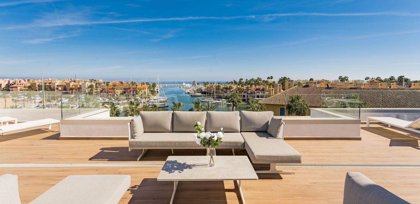 Sotogrande 2 Luxury rooftop terrace overlooking Sotogrande Marina with yachts, Mediterranean views, and elegant outdoor seating.